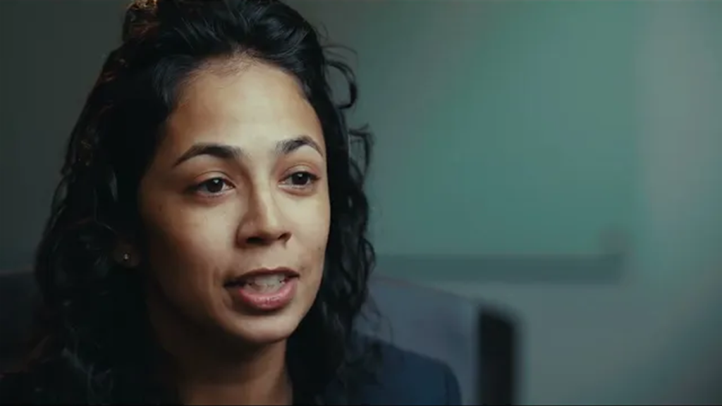 Woman in the middle of speaking looking to her left