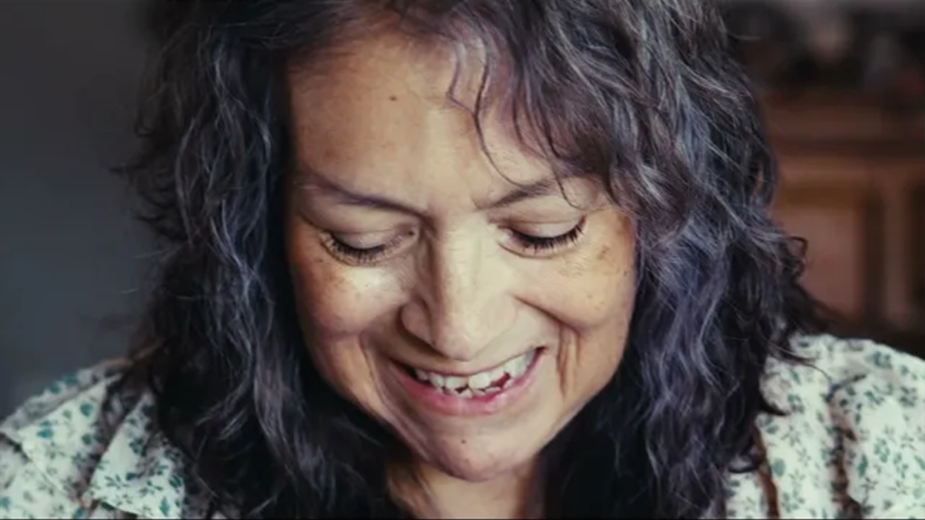 Older woman smiling and looking down